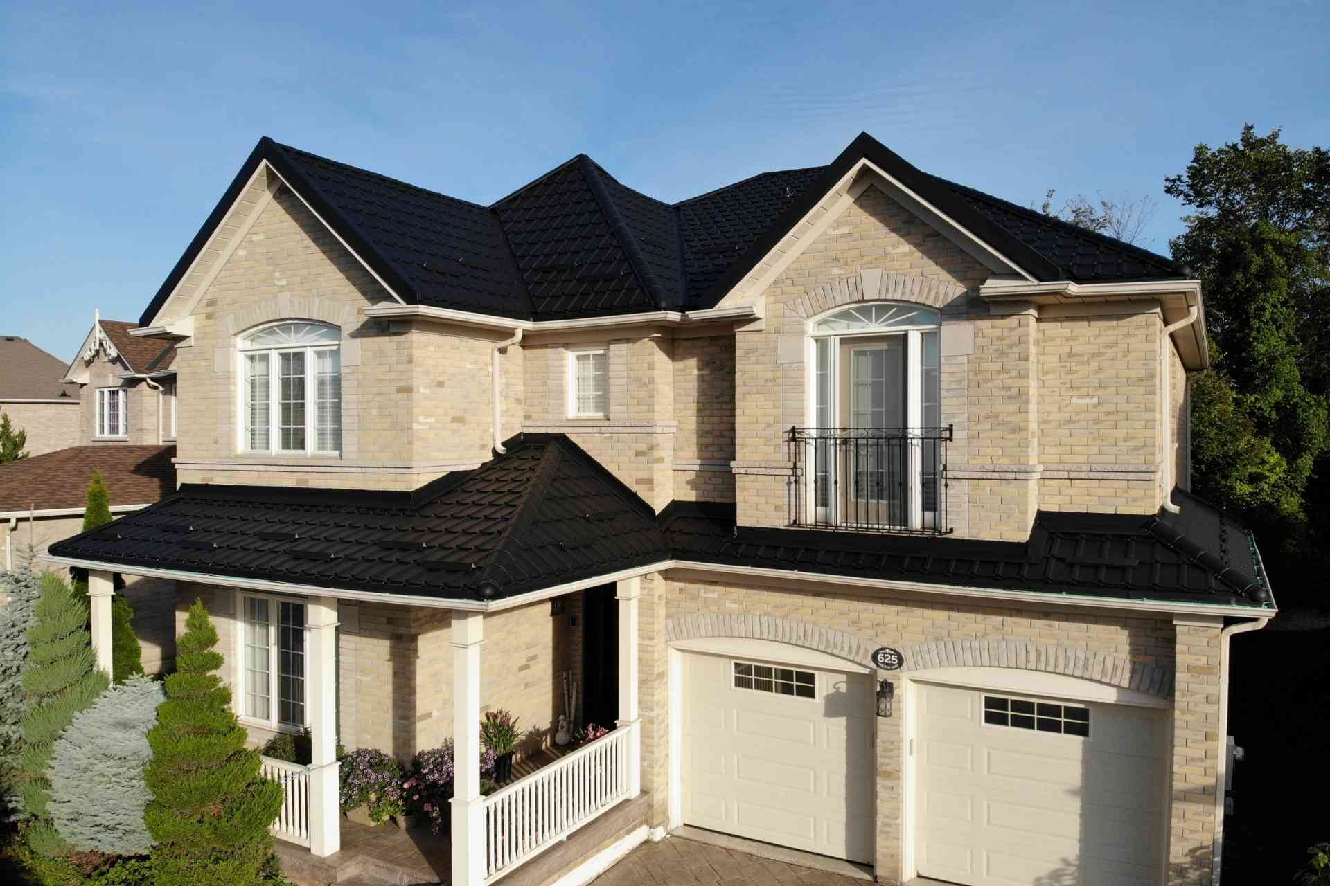 Home with dark metal tile roof